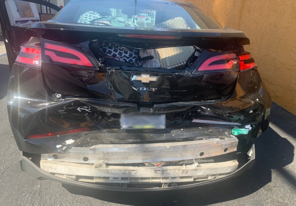Damage to the rear of the victim's car after the violent collision.
