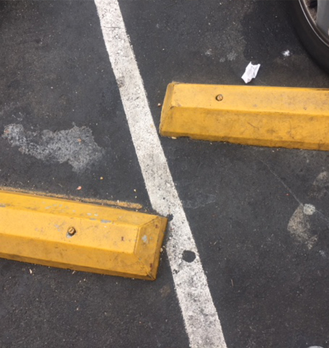 The parking lot wheel stop was defective, causing the accident with injuries.